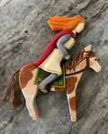Hand-painted wooden rider with crimson cape on chestnut horse