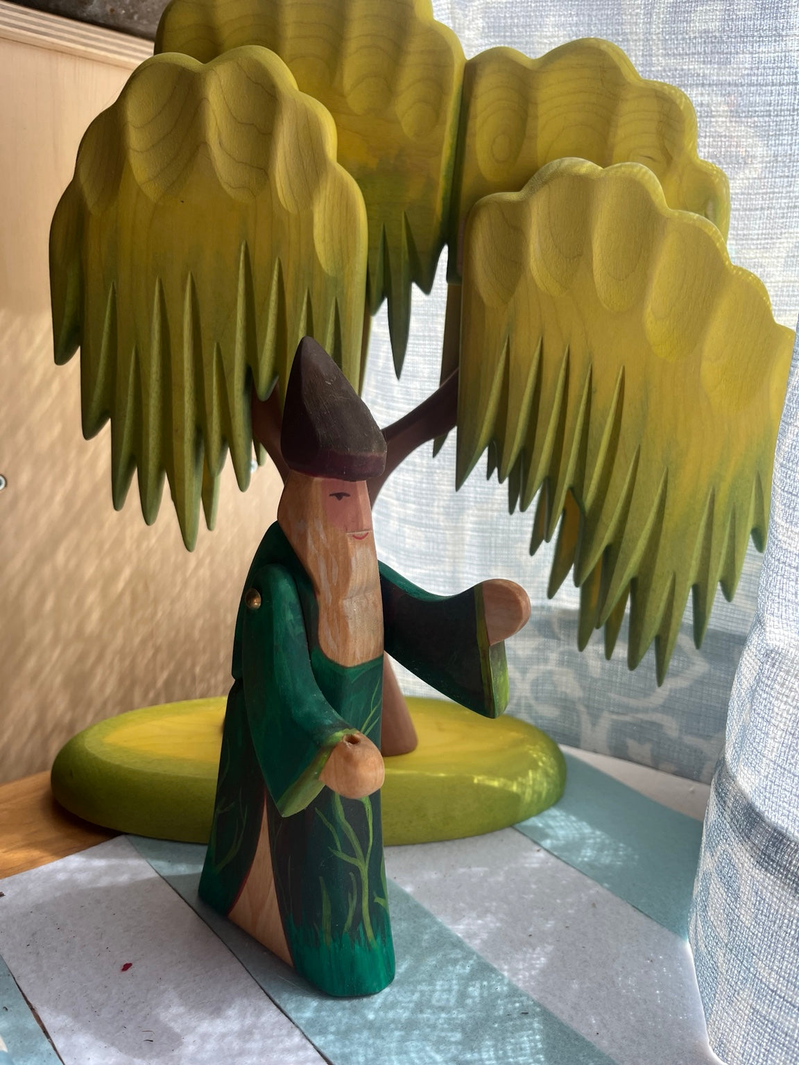 Hand-painted wooden forest wizard in deep green robes