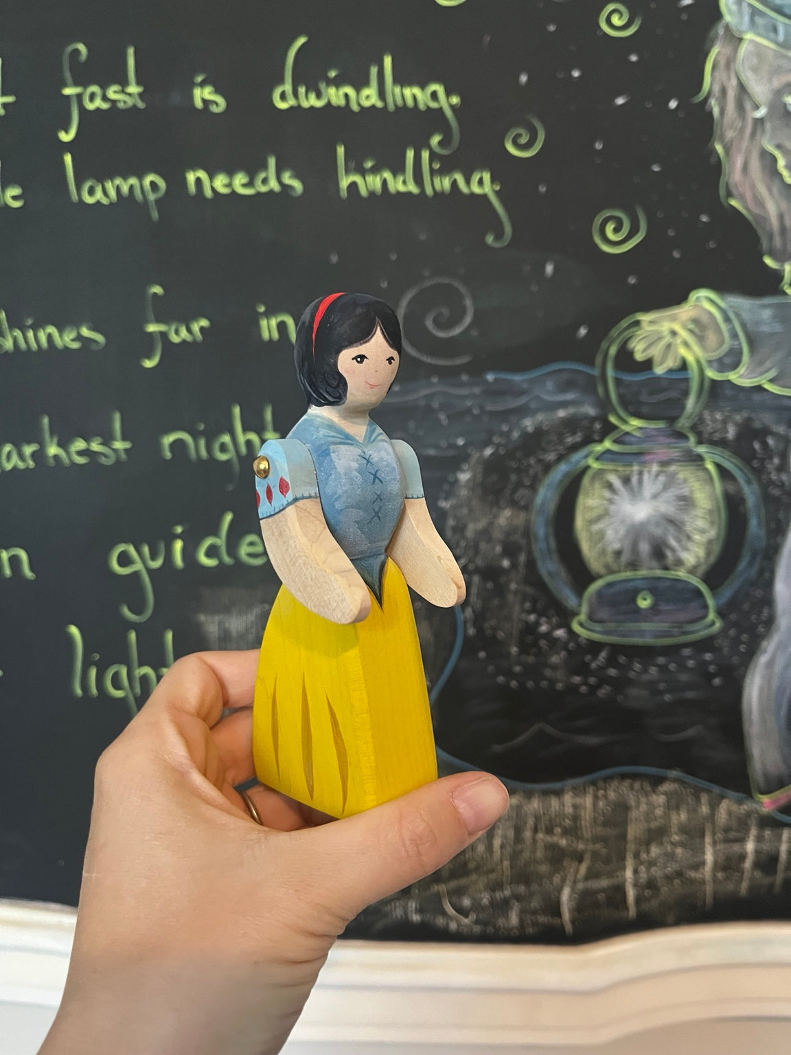 Hand-painted wooden Snow White figure with blue bodice and yellow skirt